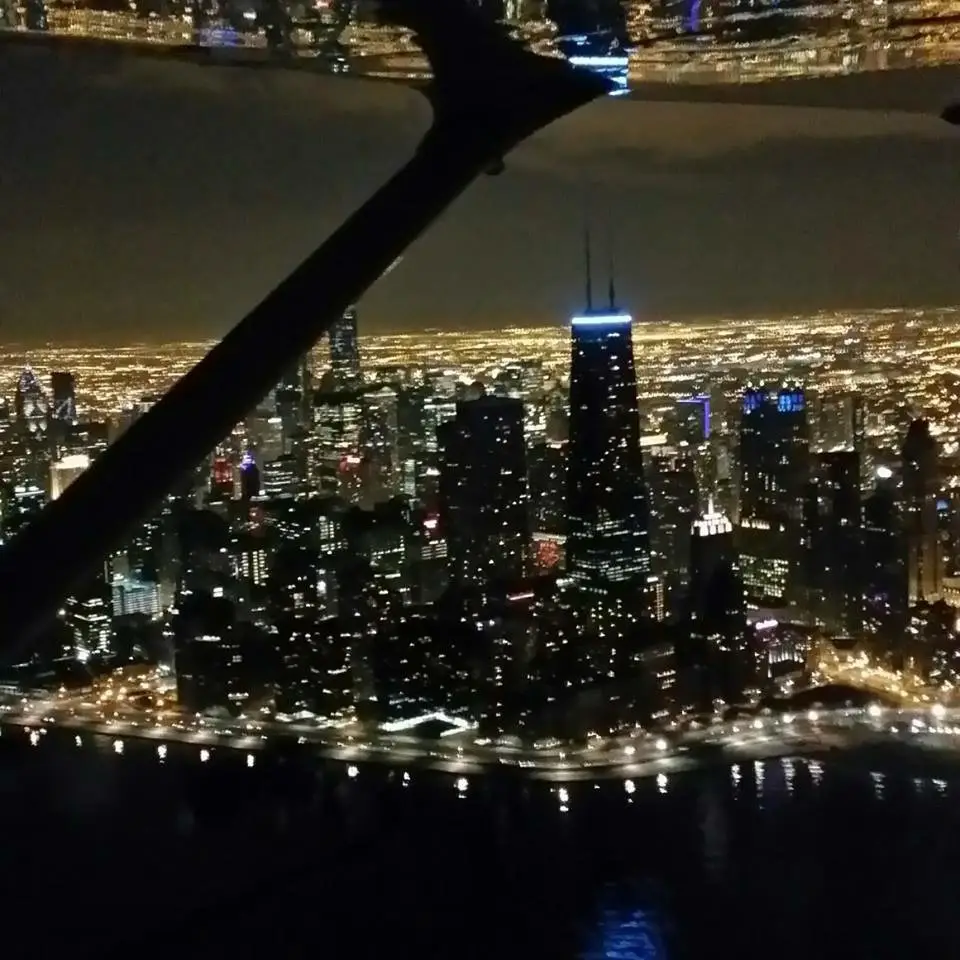 Aircraft night view over illuminated city