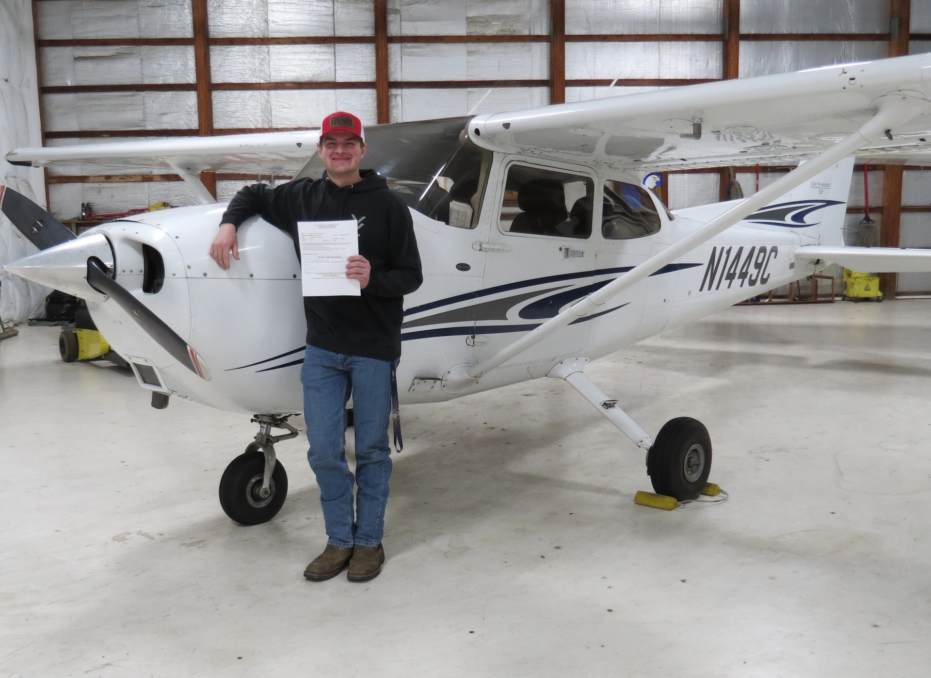 N1449C Cessna 172S student with certificate leaning on plane
