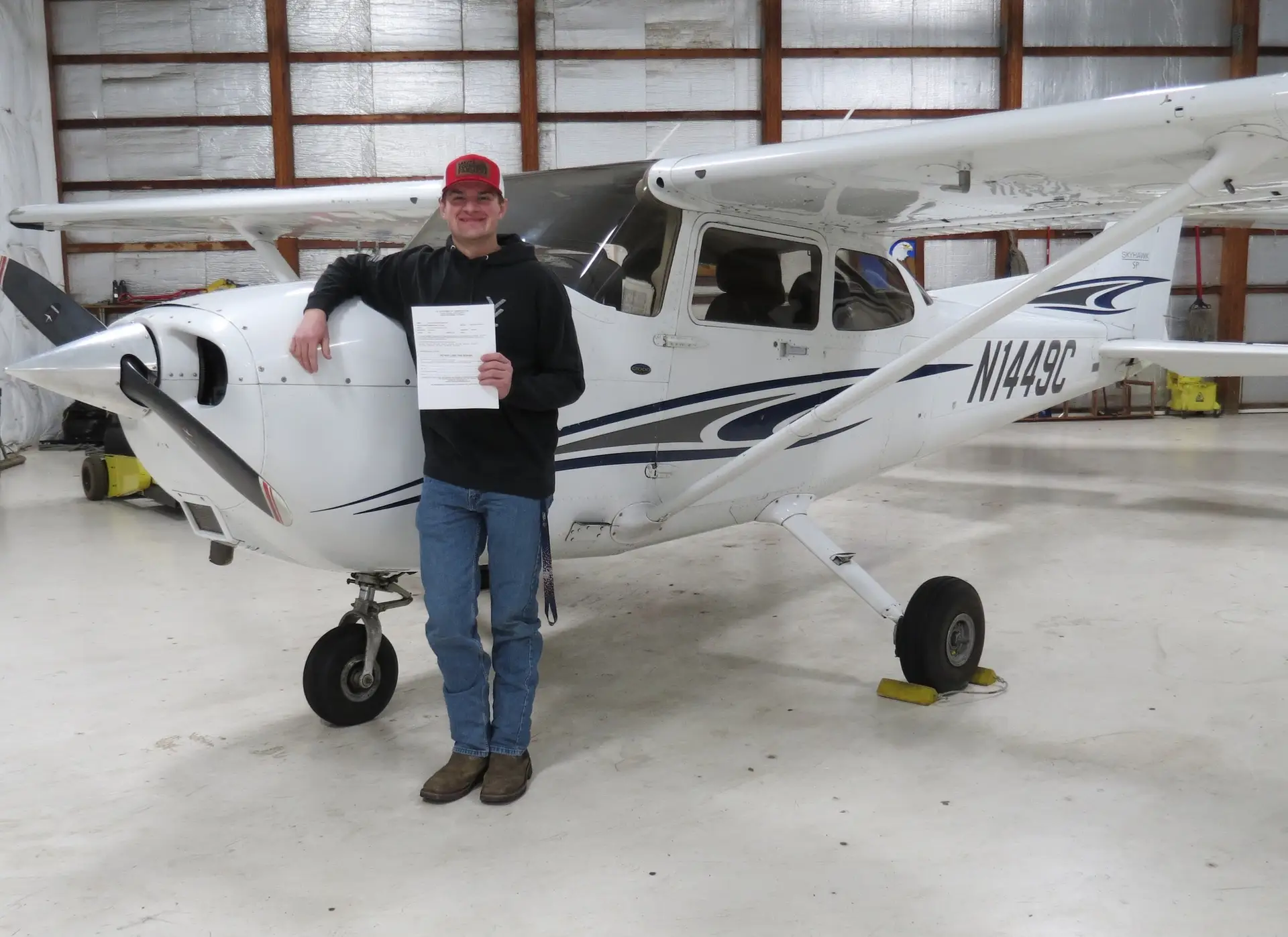 N1449C Cessna 172S student with certificate leaning on plane