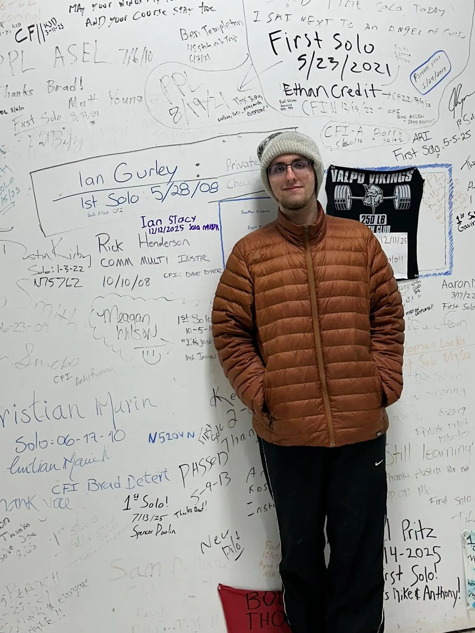 Student in front of Wall of Fame