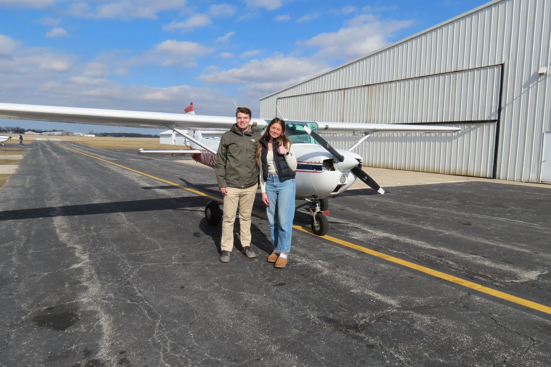 Student and instructor in front of aircraft