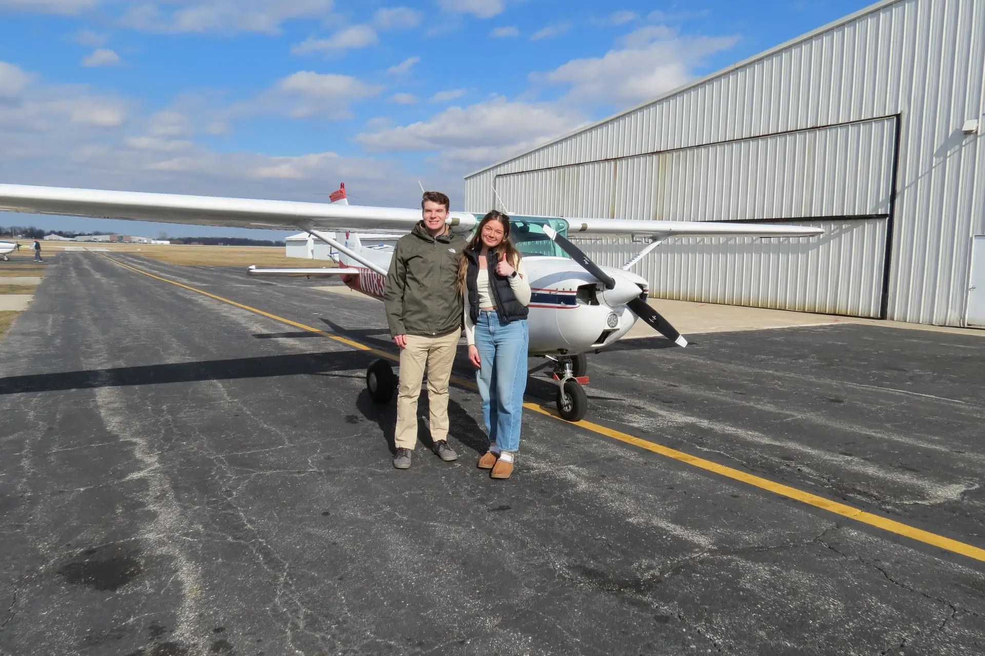 Student and instructor in front of aircraft