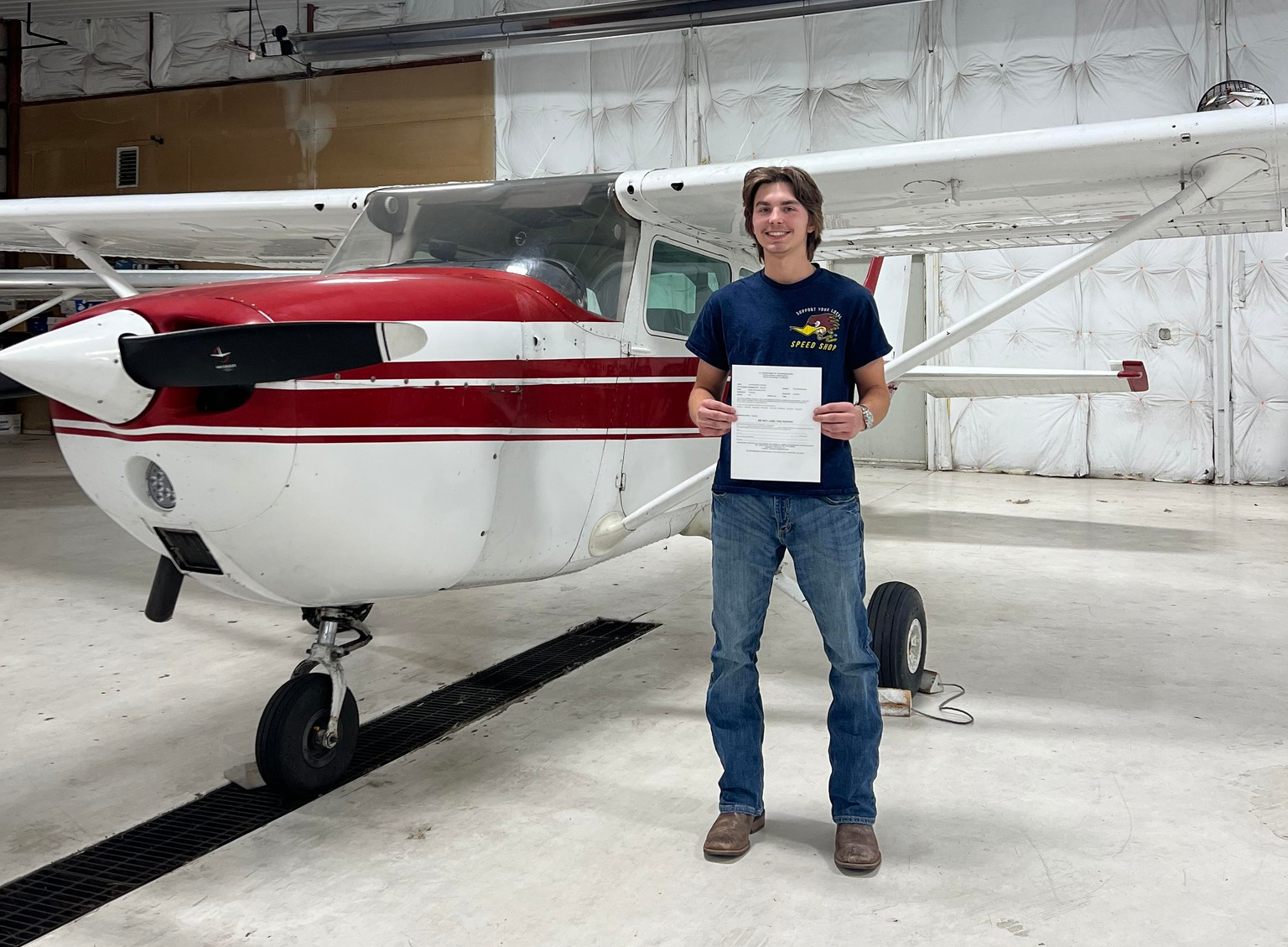 Student pilot holding earned certification in front of a Cessna 172 at Porter County Regional Airport (KVPZ)